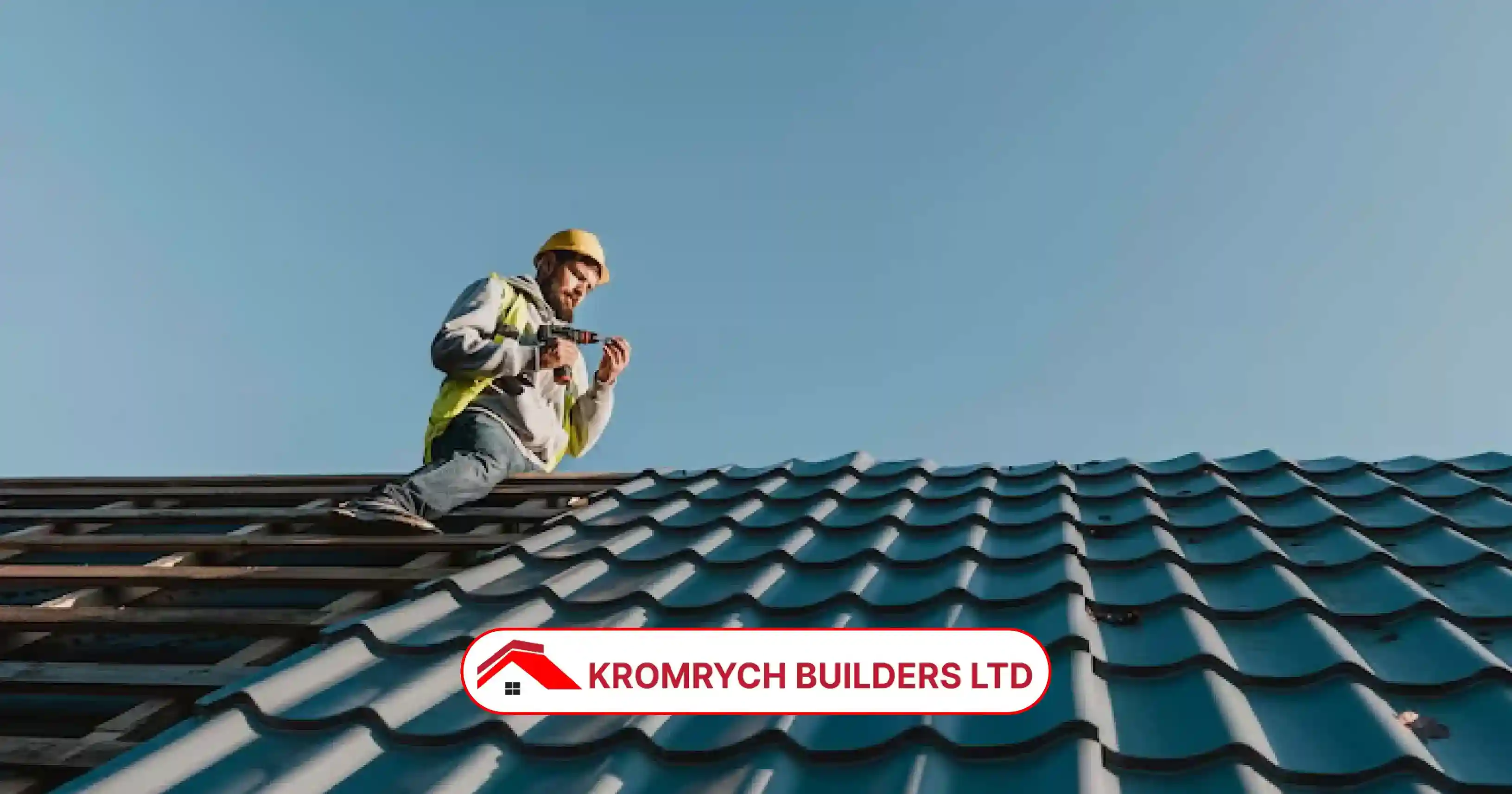 A professional roofer from Kromrych Builders installing a blue tiled roof on a residential building under clear sky in the UK.
